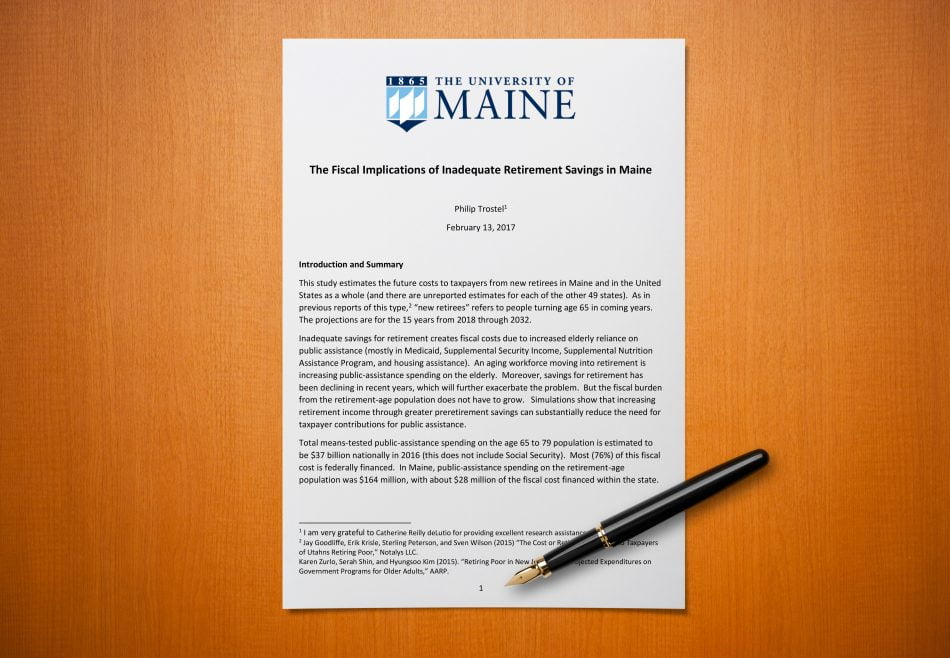 A printed copy of the UMaine report on a desk